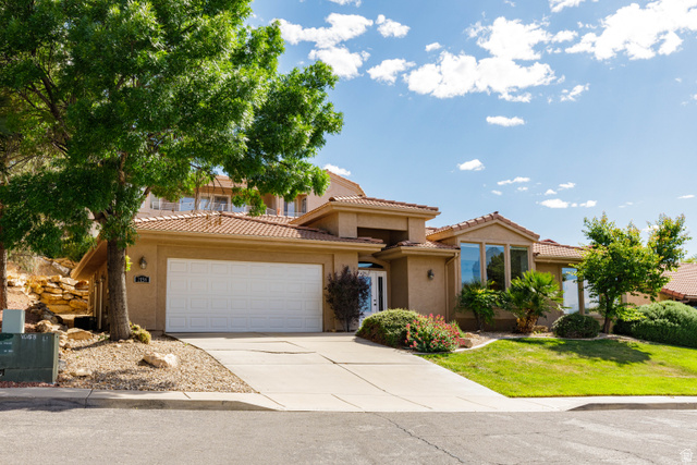 2158 Balboa Way St. George, UT 84770 - Photo 33 of 40 Stucco exterior home featuring a terracotta-style tile roof, a two-car garage, and multiple large windows