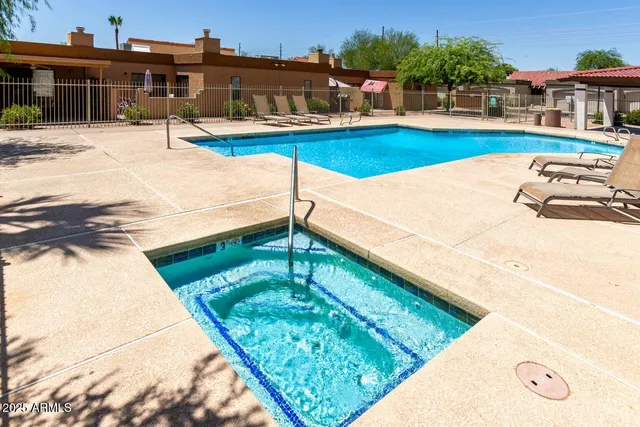a swimming pool with outdoor seating and yard