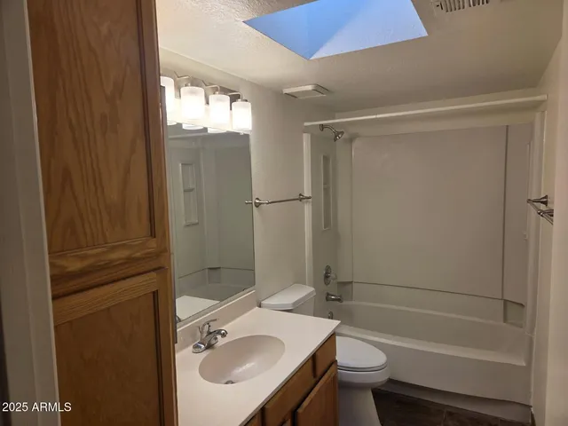 an empty room with fireplace and fan