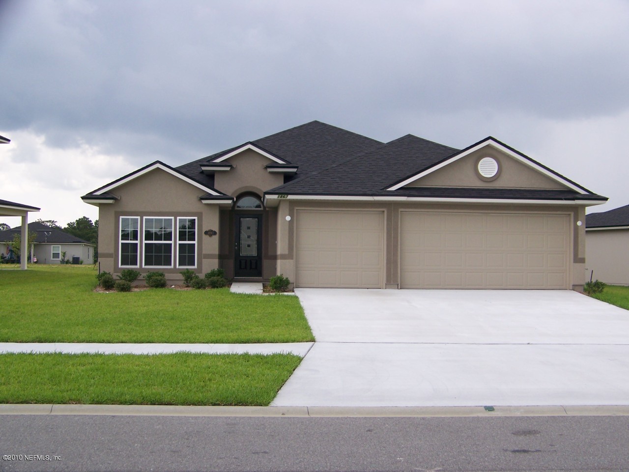 1867 Reed Valley Way, Unit AZALEA RIDGE LOT 133 Middleburg, FL 32068 - Photo 1 of 17 a front view of a house with a garden
