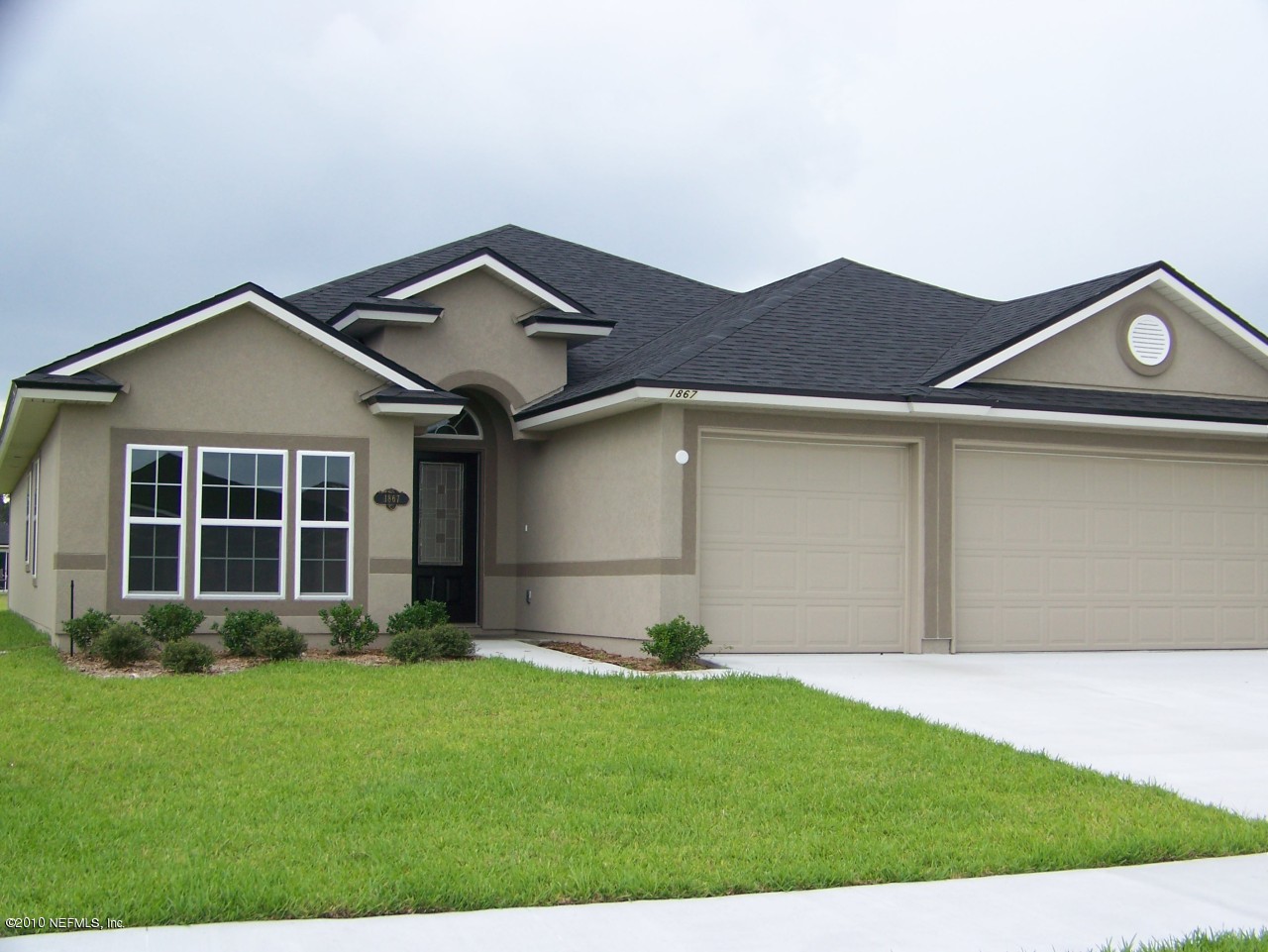 1867 Reed Valley Way, Unit AZALEA RIDGE LOT 133 Middleburg, FL 32068 - Photo 2 of 17 a front view of a house with a garden and yard