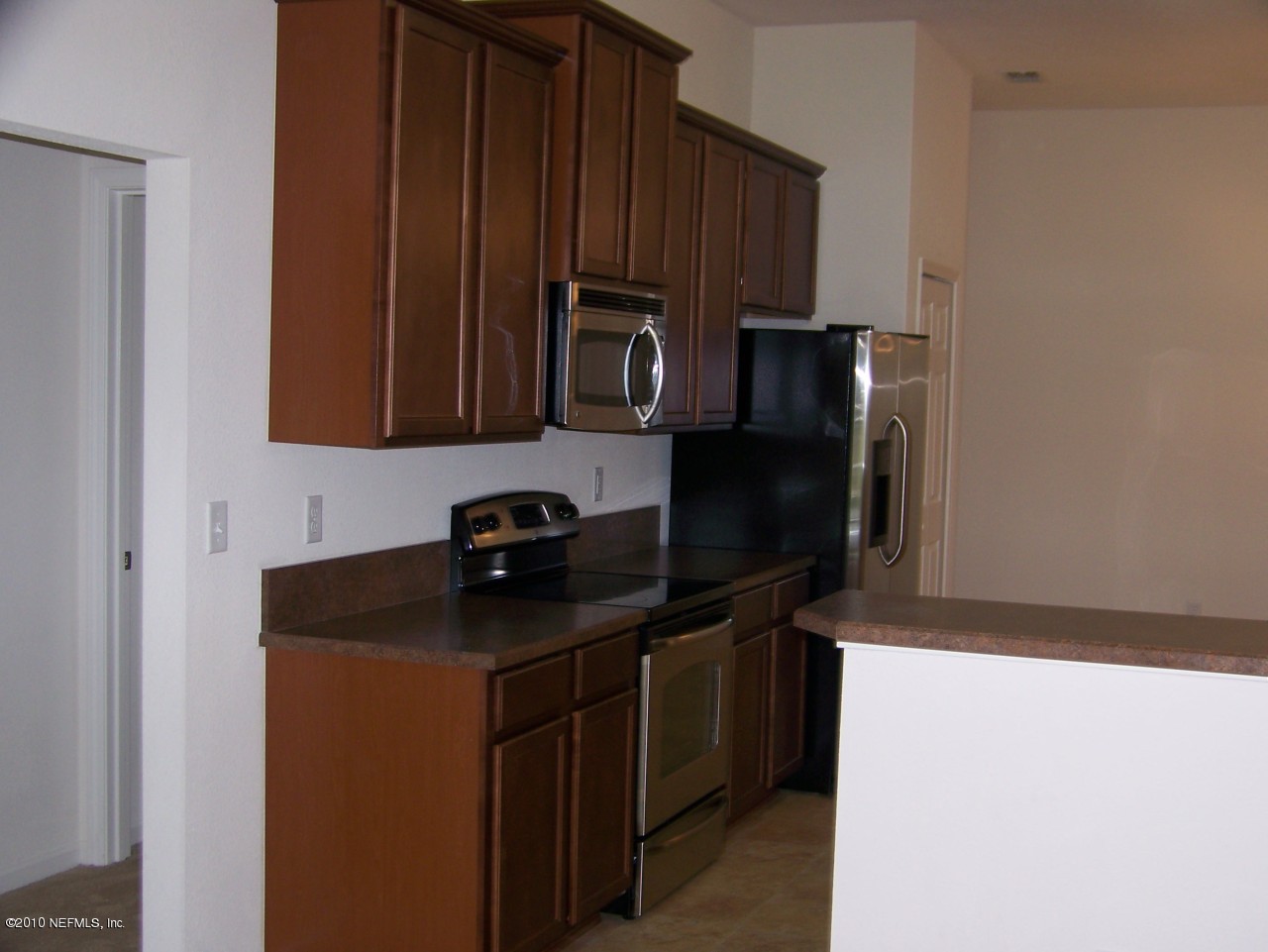 1867 Reed Valley Way, Unit AZALEA RIDGE LOT 133 Middleburg, FL 32068 - Photo 4 of 17 a kitchen with stainless steel appliances granite countertop a refrigerator and a stove top oven