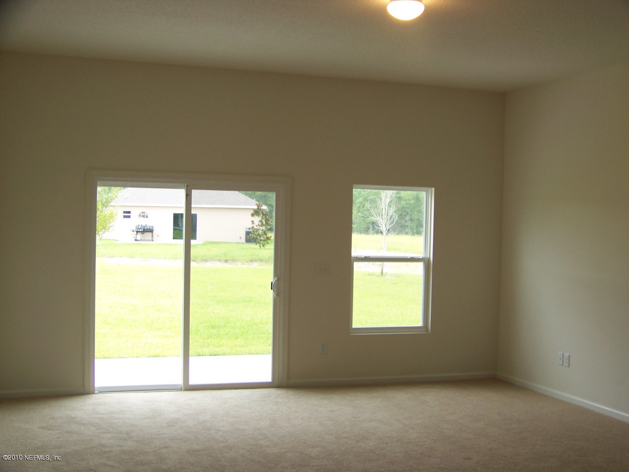 1867 Reed Valley Way, Unit AZALEA RIDGE LOT 133 Middleburg, FL 32068 - Photo 6 of 17 a view of an empty room with a window
