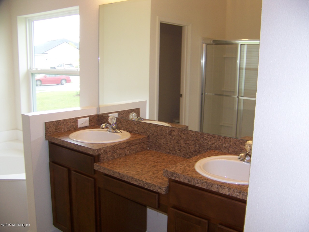 1867 Reed Valley Way, Unit AZALEA RIDGE LOT 133 Middleburg, FL 32068 - Photo 7 of 17 a bathroom with a granite countertop sink and a mirror