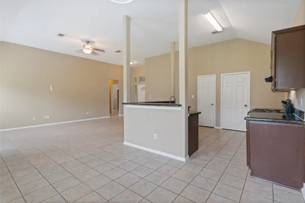 an empty room with kitchen view and appliances