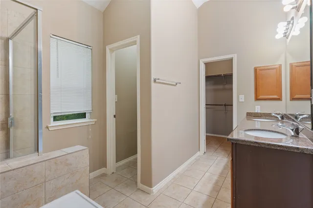 a white bath tub sitting next to a shower