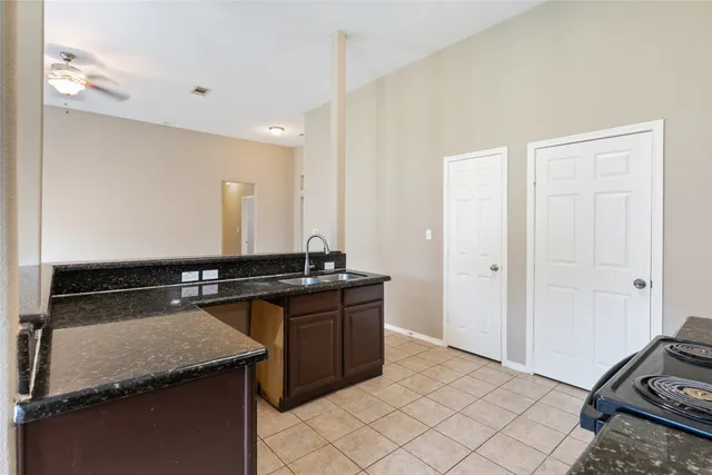 a house view with swimming pool and trees in the background