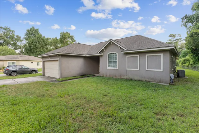 a view of a house with a yard and tree s