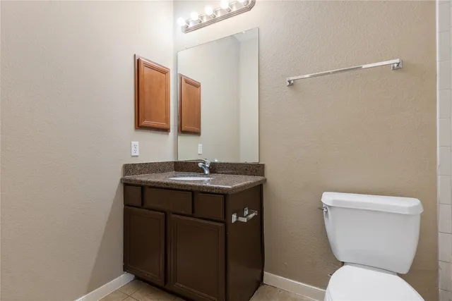 a bathroom with a toilet a sink and mirror
