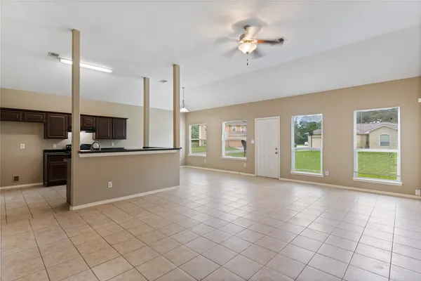 a view of a kitchen with furniture and a ceiling fan