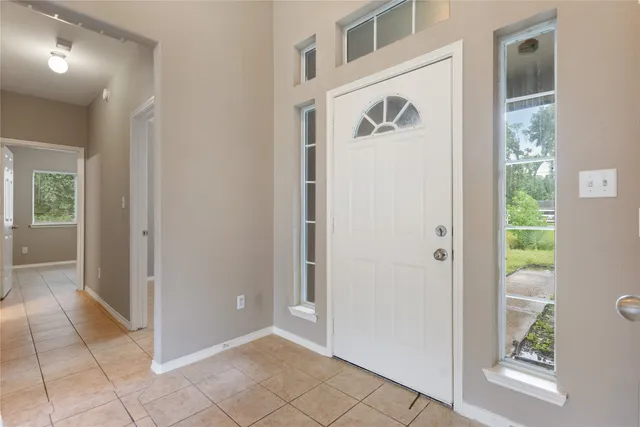 a view of a hallway to rooms and stairs