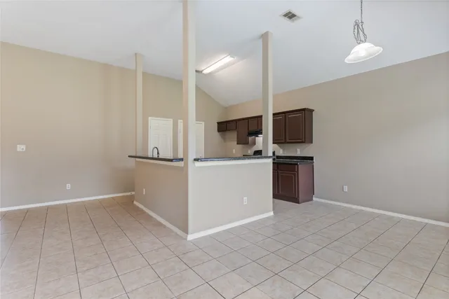 a kitchen with cabinets and white stainless steel appliances