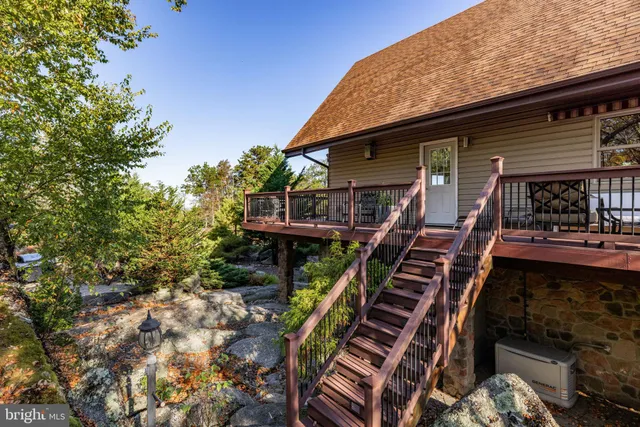a living room with fireplace furniture and a large window
