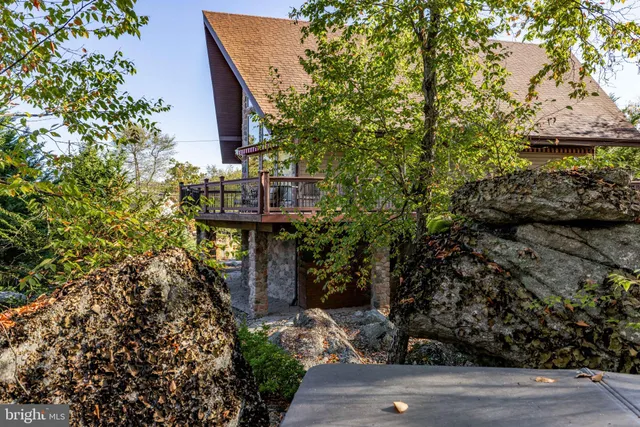 a bedroom with a large bed and a flat tv screen on dresser