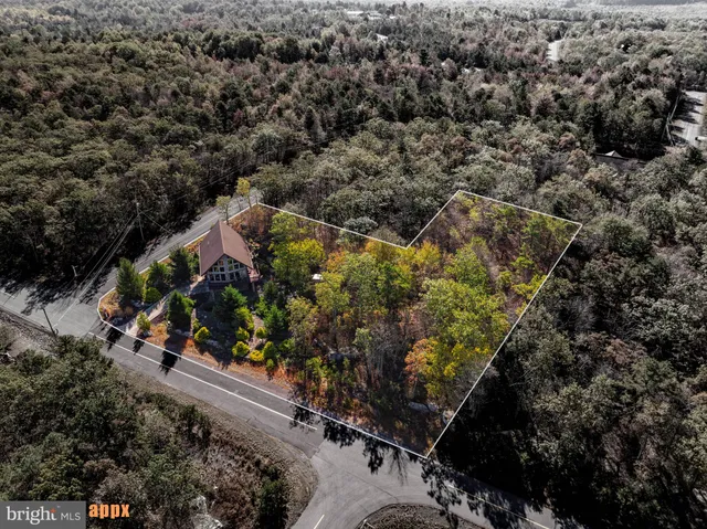 a balcony with wooden floor and outdoor seating