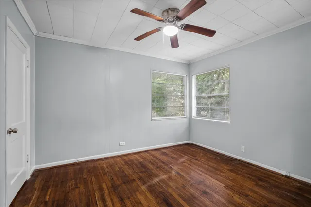 wooden floor in an empty room with a window