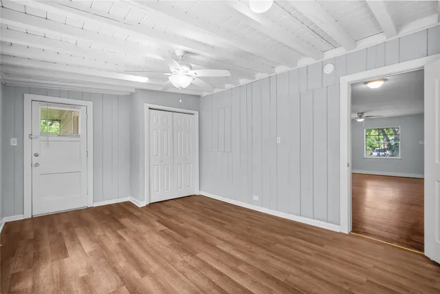 wooden floor in an empty room with a window