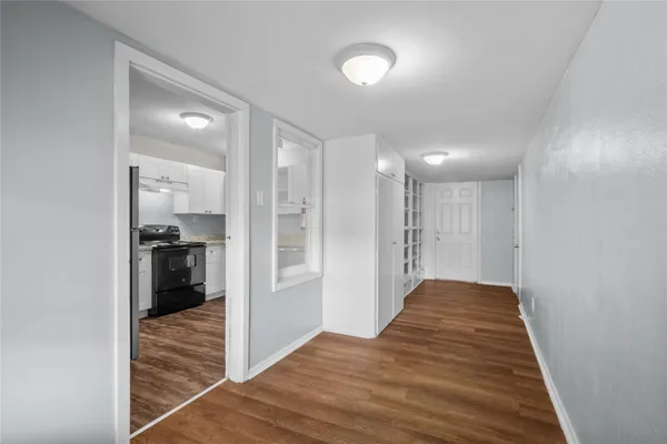 a view of a hallway to a bedroom and a window