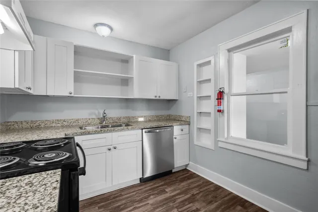 a kitchen with stainless steel appliances granite countertop a stove and a refrigerator