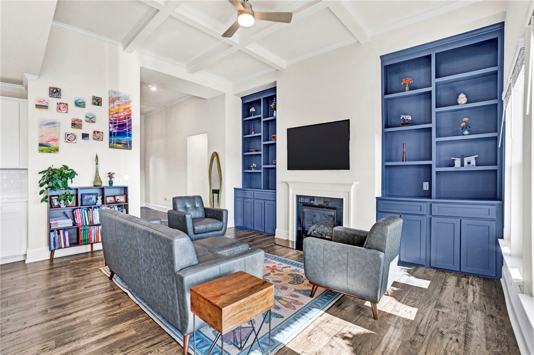142 Juniper Hill Drive Easley, SC 29642 - Photo 19 of 47 This bright living space features built-in shelving, a cozy fireplace, and rich wood flooring.
