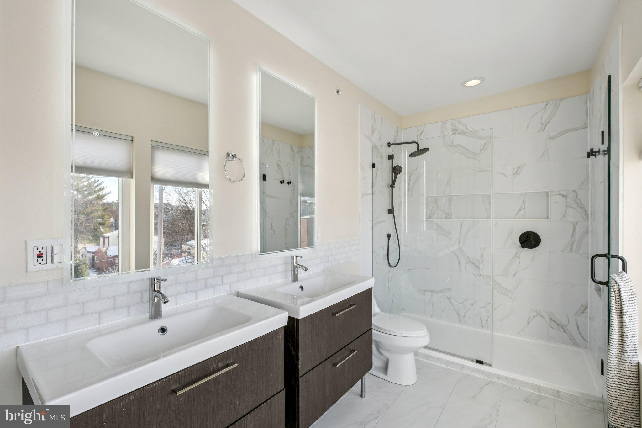 1189 South 21st Street Philadelphia, PA 19146 - Photo 15 of 30 a bathroom with a shower sink vanity mirror and toilet