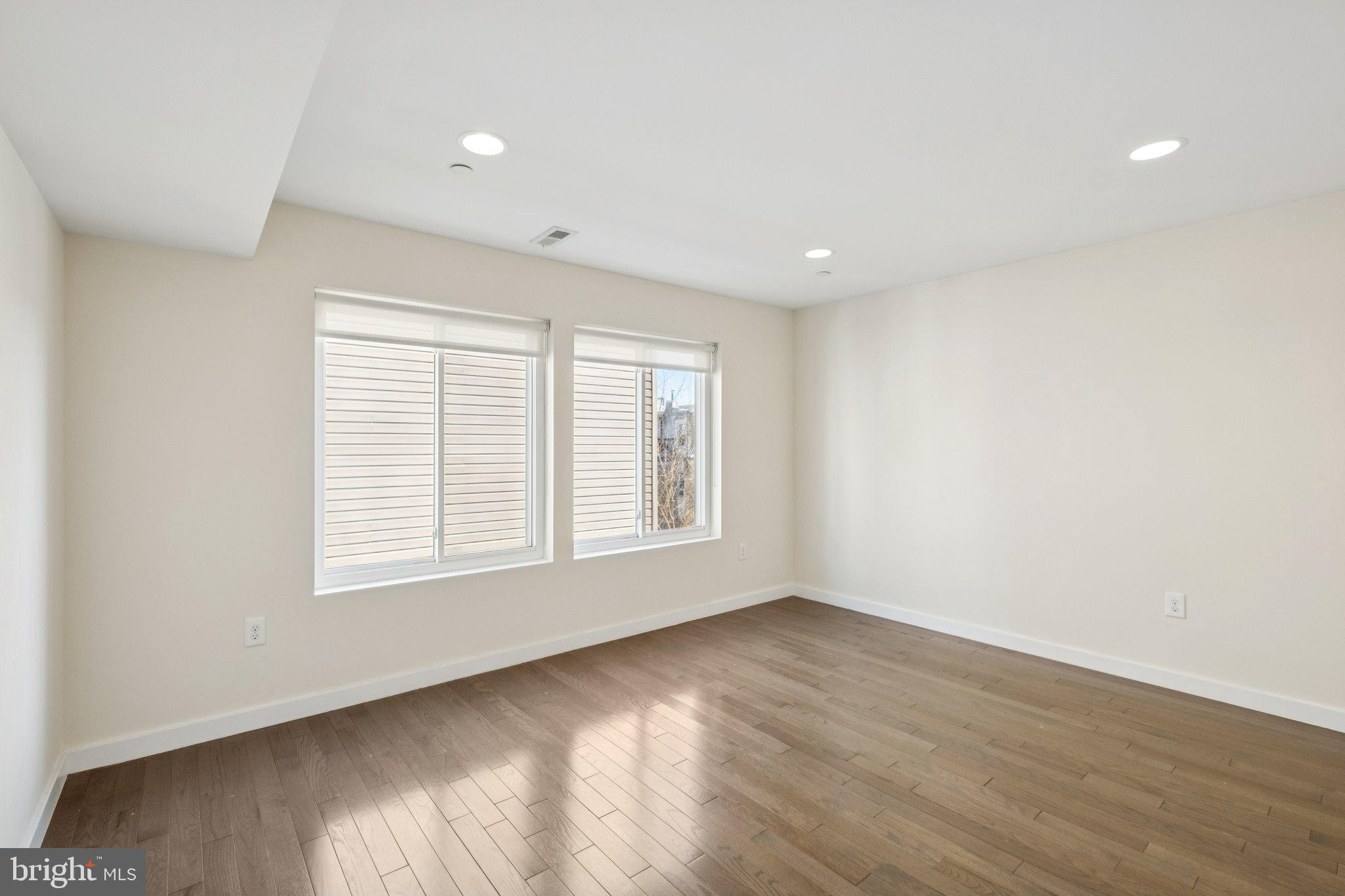 1189 South 21st Street Philadelphia, PA 19146 - Photo 18 of 30 a view of an empty room with wooden floor and a window
