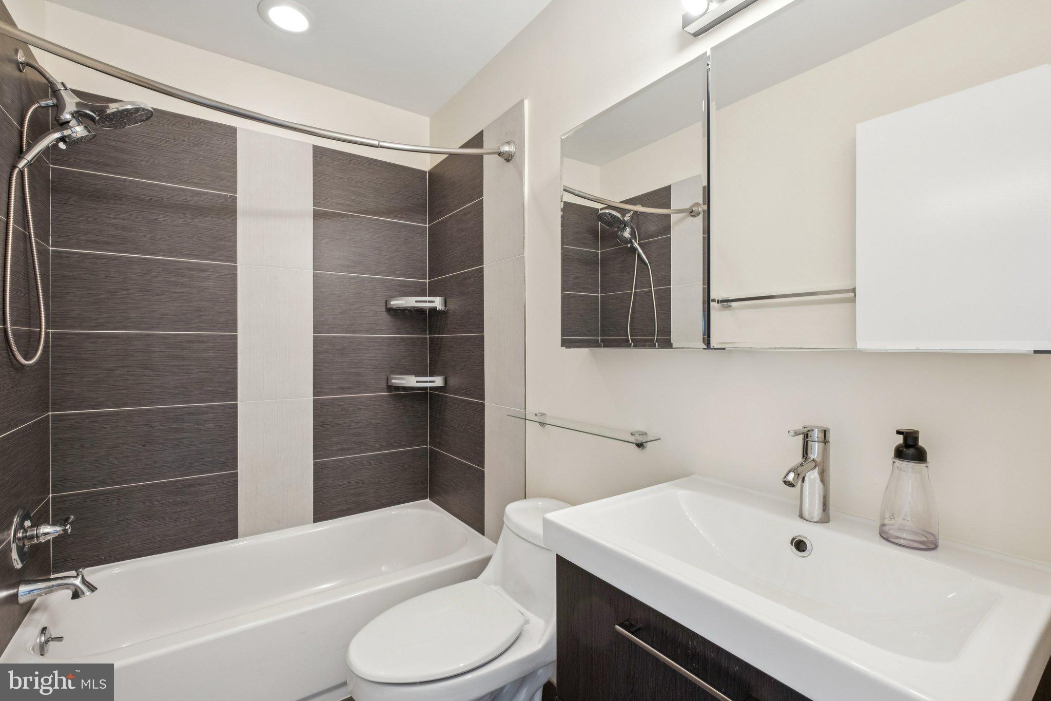 1189 South 21st Street Philadelphia, PA 19146 - Photo 19 of 30 a bathroom with a sink toilet and shower