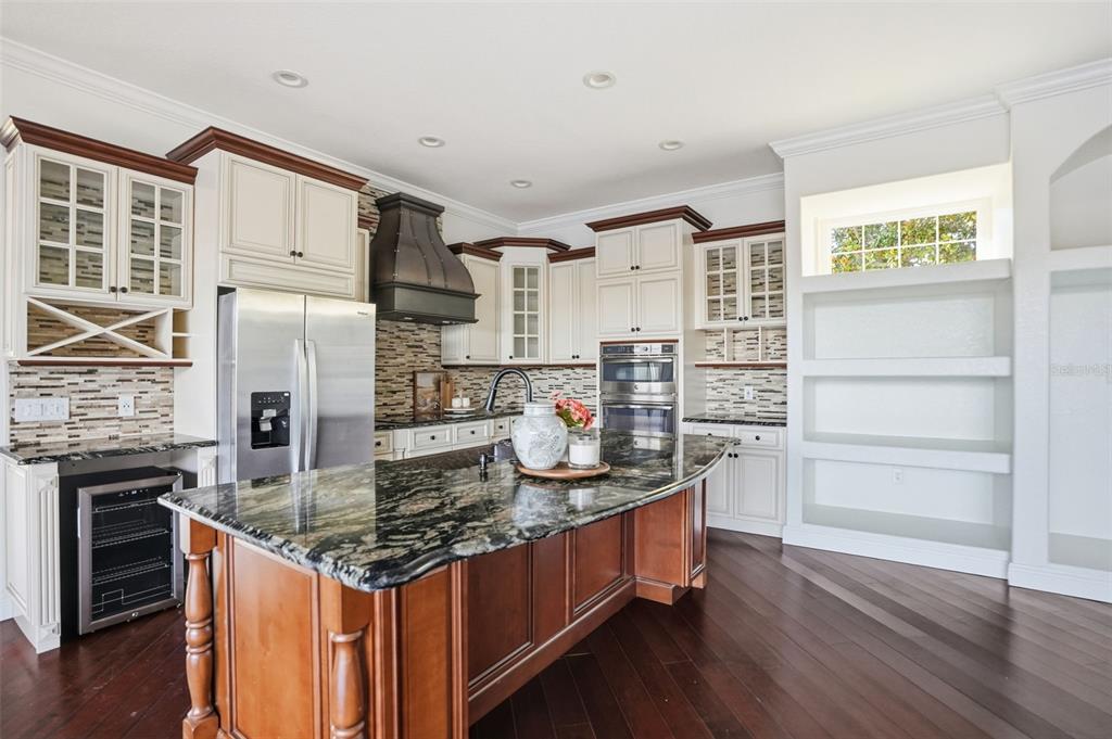 4495 Secretariat Run Spring Hill, FL 34609 - Photo 12 of 43 a kitchen with stainless steel appliances granite countertop a stove and a refrigerator