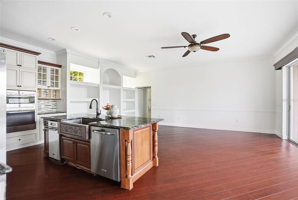 4495 Secretariat Run Spring Hill, FL 34609 - Photo 14 of 43 a kitchen with stainless steel appliances granite countertop a stove and a sink