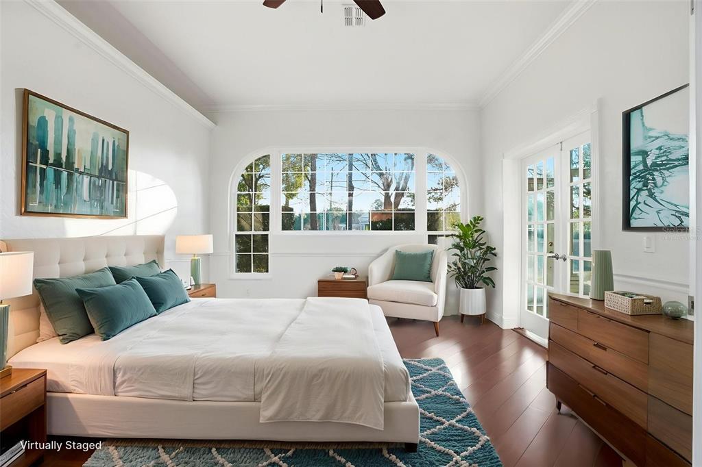 4495 Secretariat Run Spring Hill, FL 34609 - Photo 22 of 43 a bedroom with a large bed and wooden floor