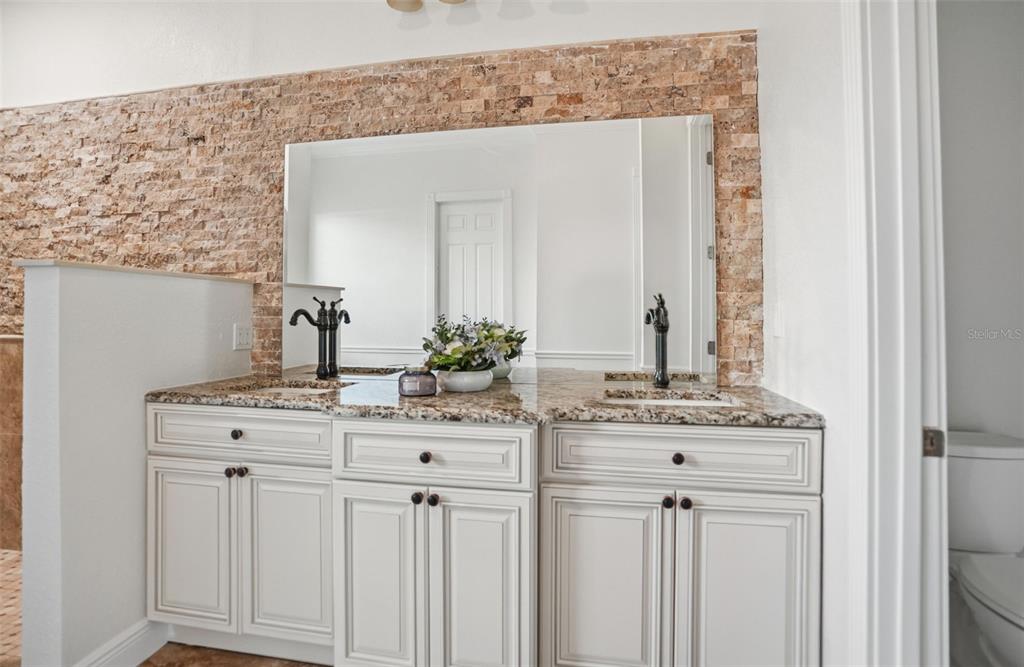 4495 Secretariat Run Spring Hill, FL 34609 - Photo 25 of 43 a bathroom with a granite countertop sink and a mirror