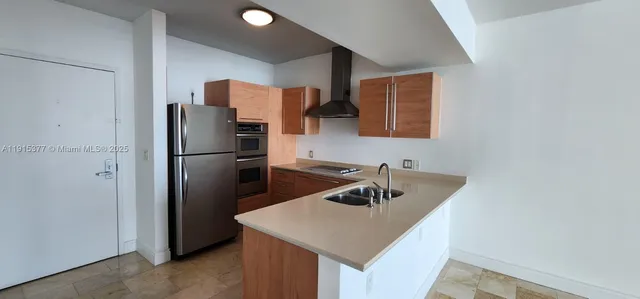 a kitchen with a refrigerator a sink and a refrigerator