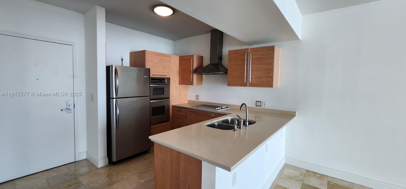 a kitchen with a refrigerator a sink and a refrigerator