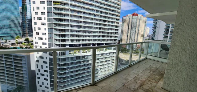 a view of balcony with wooden floor and shower