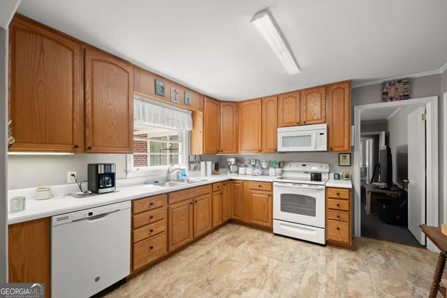 a kitchen with stainless steel appliances granite countertop a stove sink and refrigerator