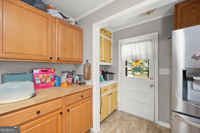 a kitchen with stainless steel appliances wooden floor and a refrigerator