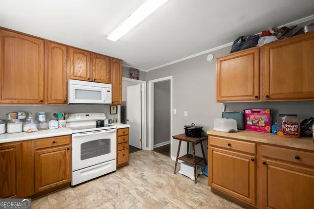 a kitchen with a sink cabinets and window