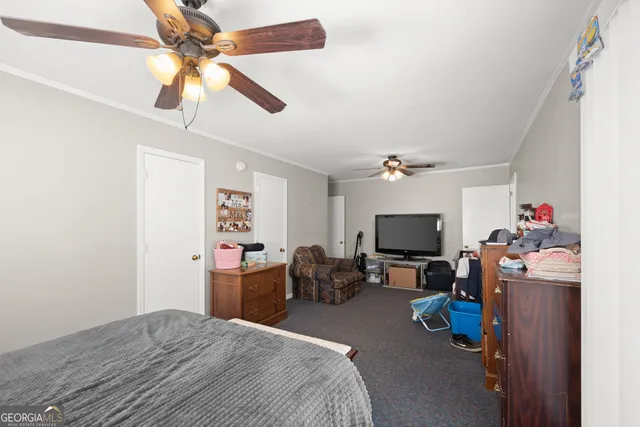 a bedroom with furniture and a flat screen tv
