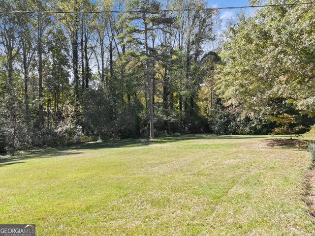 a view of a swimming pool and trees