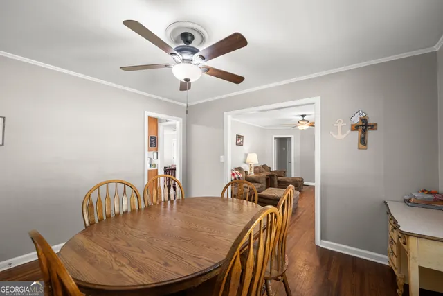 a view of a dining room with furniture and a chandelier