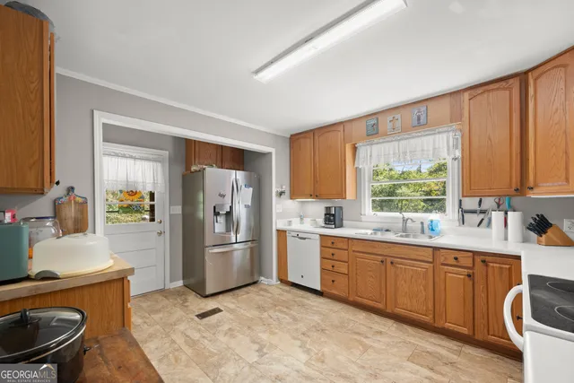 a kitchen with a sink stove and refrigerator