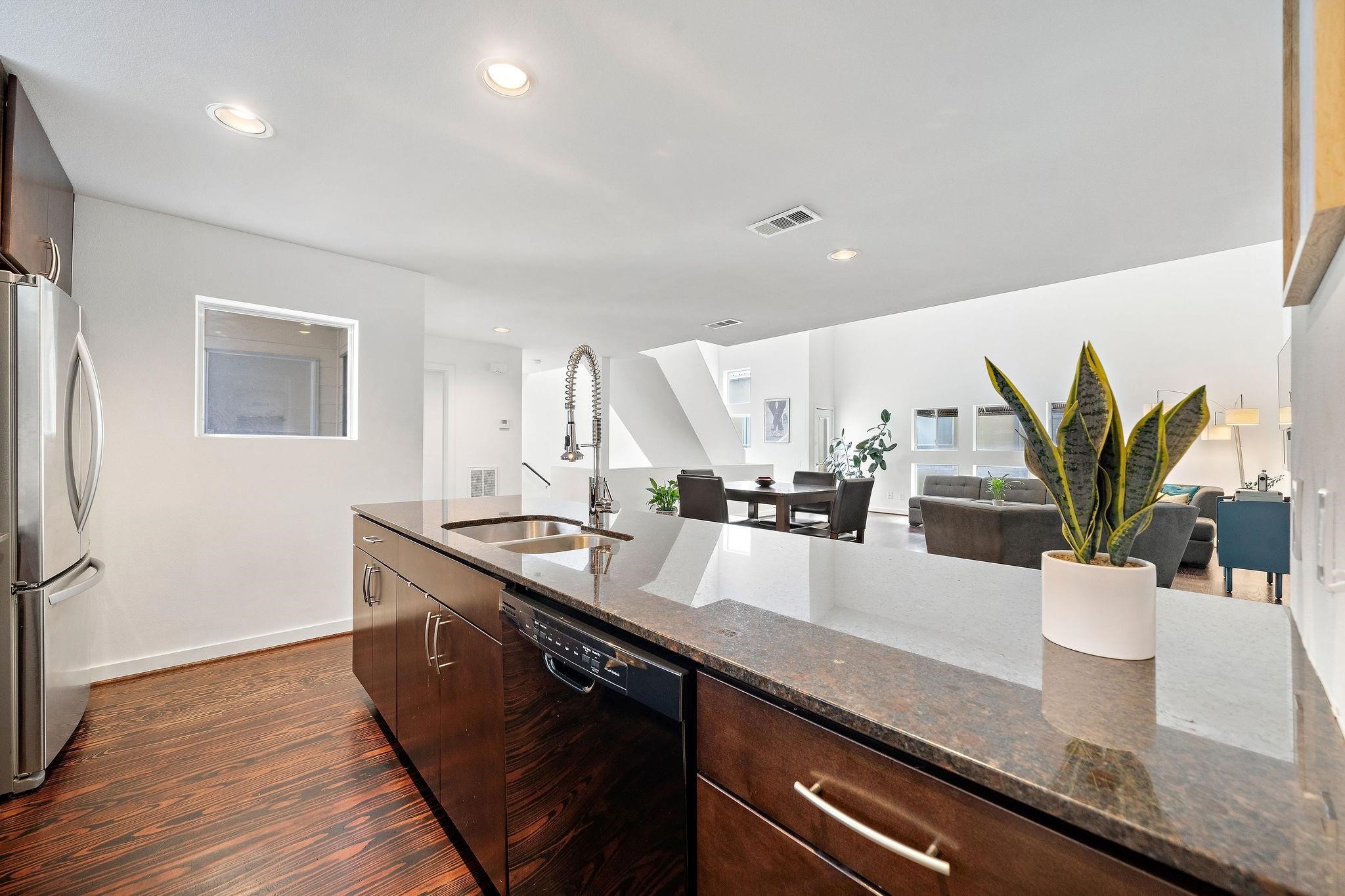 441 Meadow Street Houston, TX 77020 - Photo 11 of 20 a kitchen with granite countertop a sink a stove and wooden floor
