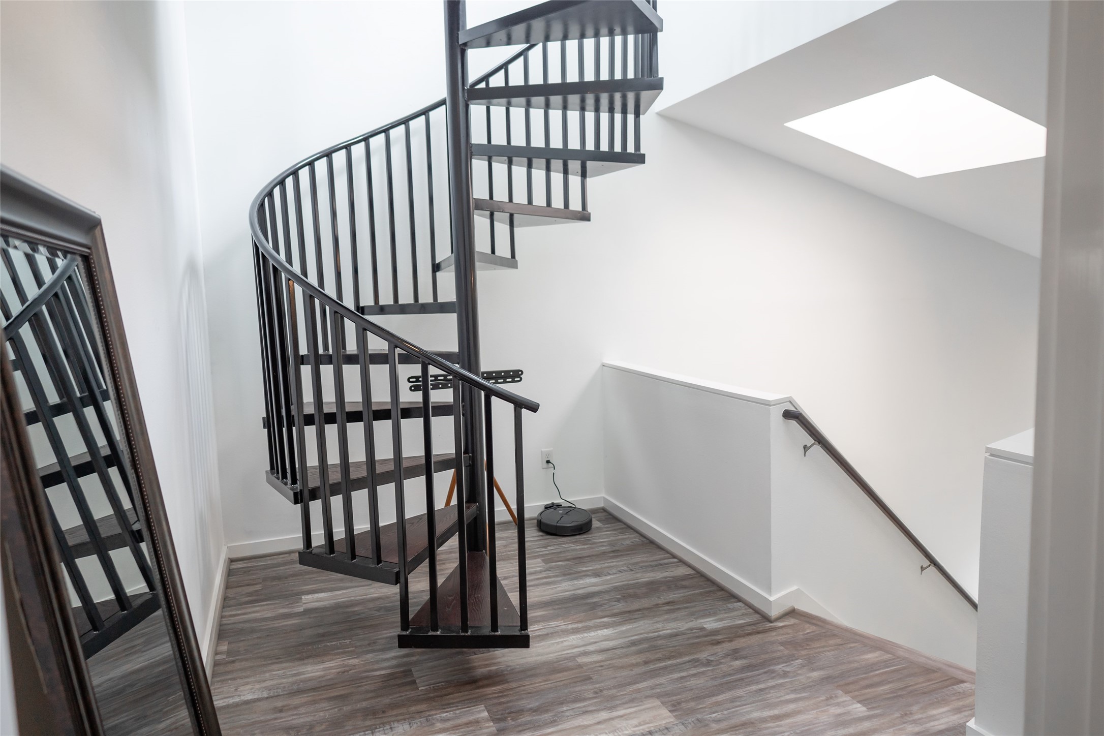 441 Meadow Street Houston, TX 77020 - Photo 9 of 20 a view of staircase with wooden floor and a window