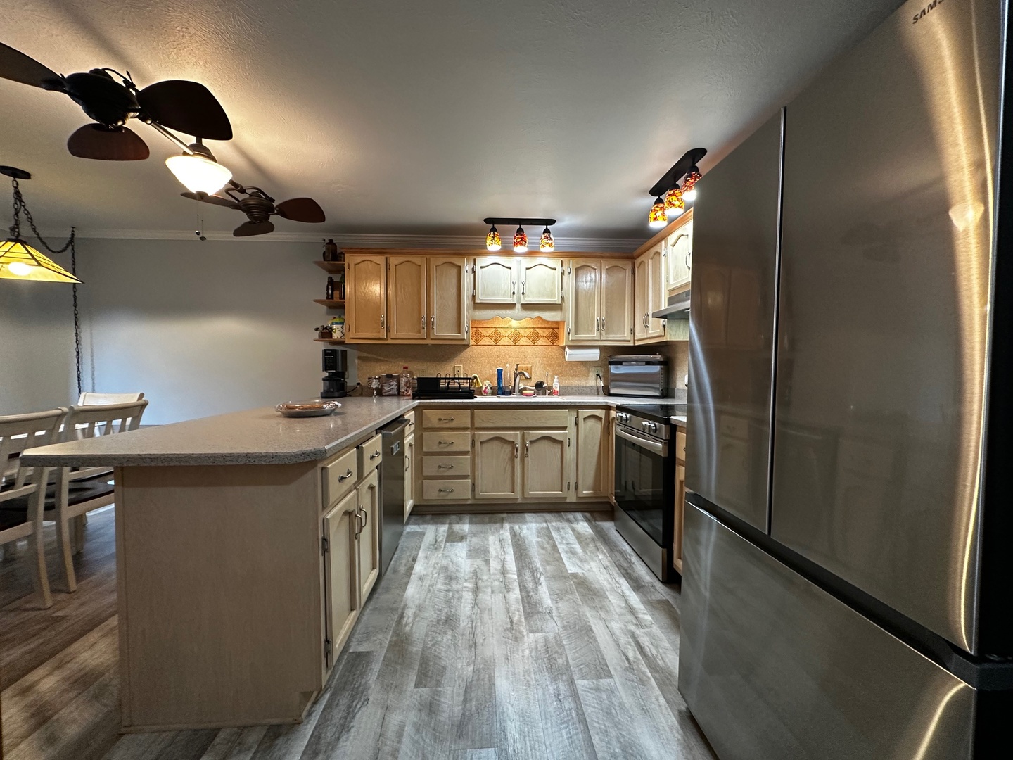 4100 416 North Clinton, IL 61727 - Photo 11 of 33 a kitchen with a sink stainless steel appliances a window and a counter top space