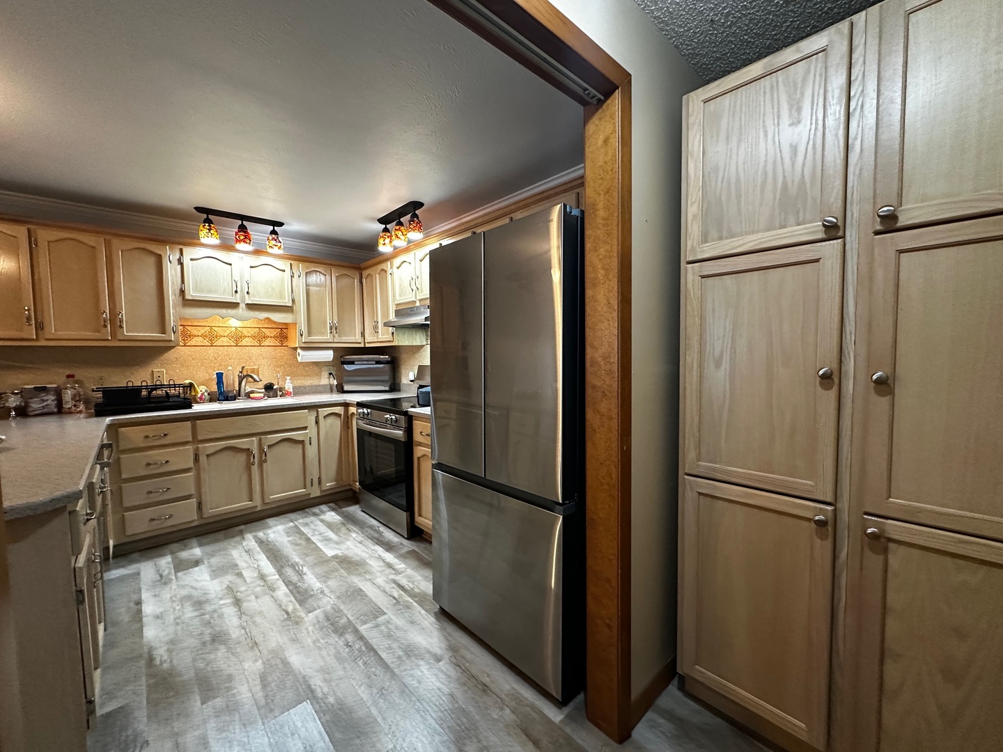 4100 416 North Clinton, IL 61727 - Photo 14 of 33 a kitchen with granite countertop stainless steel appliances a refrigerator and cabinets