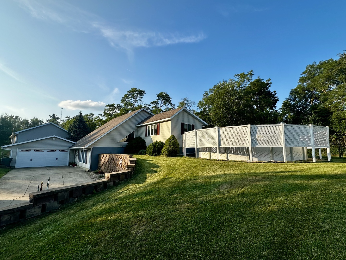 4100 416 North Clinton, IL 61727 - Photo 2 of 33 a front view of a house with a yard and garage