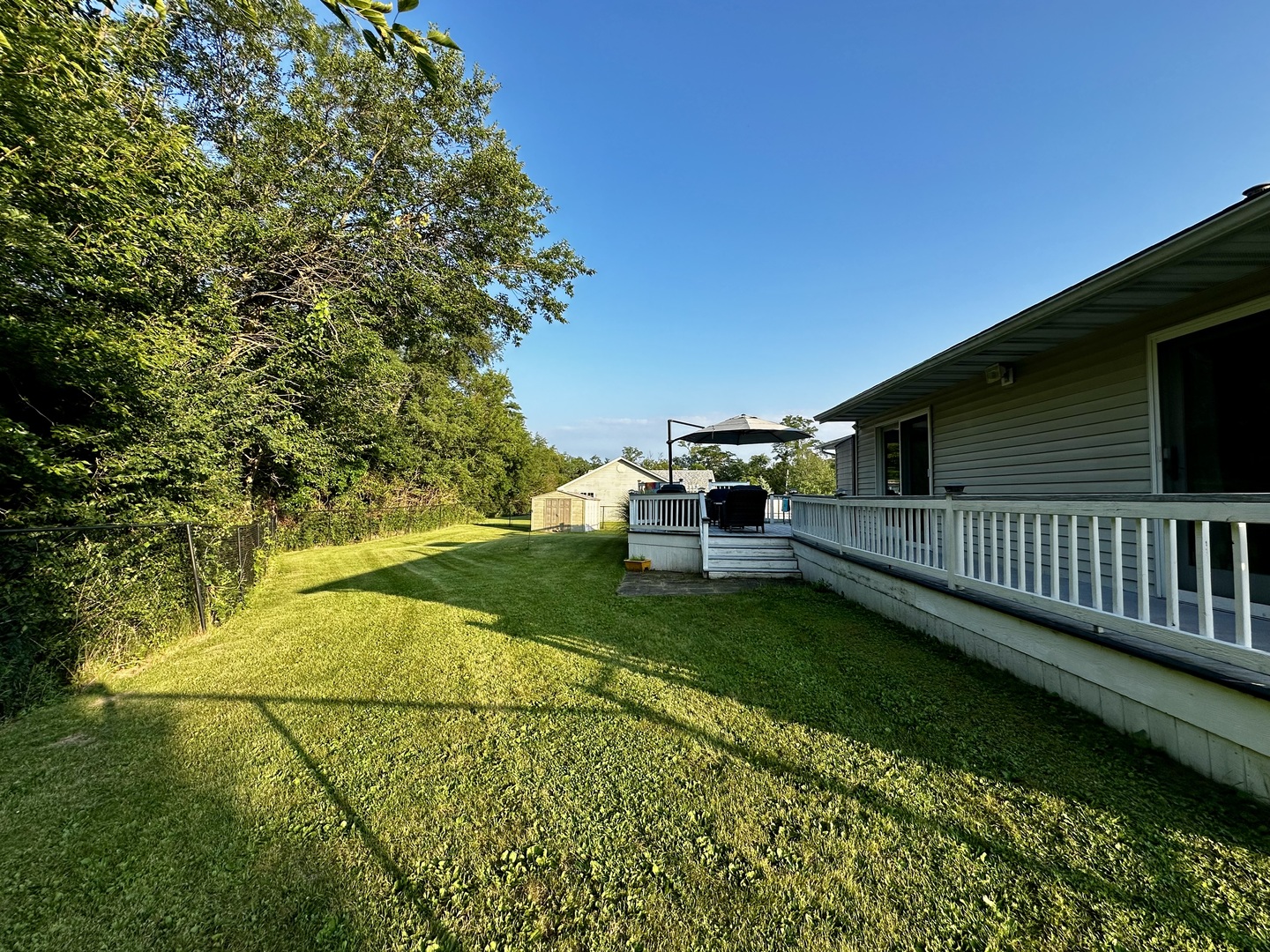4100 416 North Clinton, IL 61727 - Photo 32 of 33 a view of backyard with deck and garden