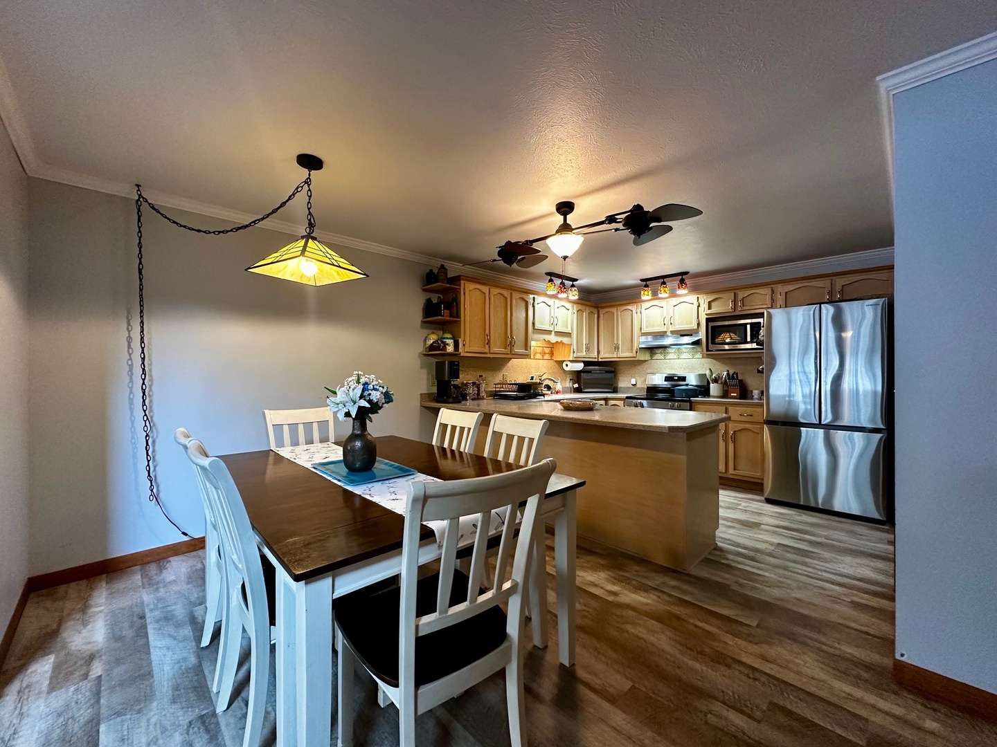 4100 416 North Clinton, IL 61727 - Photo 9 of 33 a kitchen with a table chairs and a refrigerator