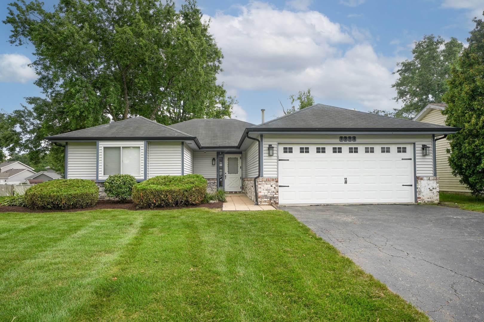 1214 Needham Road Naperville, IL 60563 - Photo 1 of 25 a front view of a house with a yard and garage