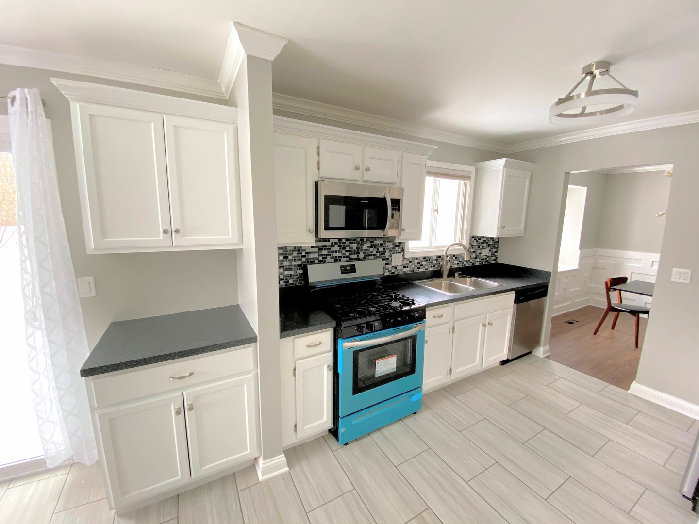 1214 Needham Road Naperville, IL 60563 - Photo 14 of 25 a kitchen with granite countertop a stove a sink and a microwave
